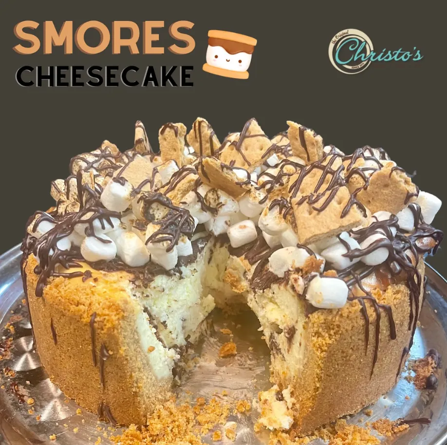 A s’mores cheesecake cut open, marshmallow and chocolate on top